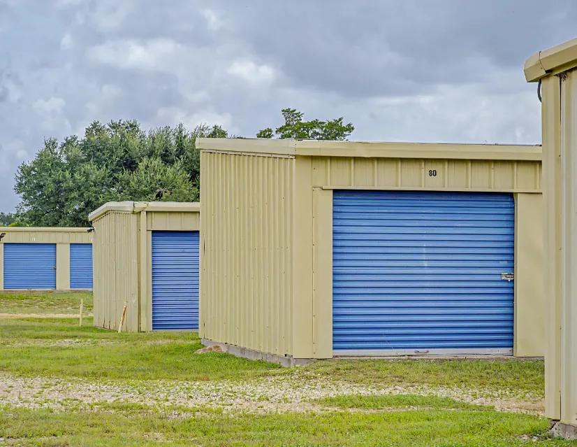 Larger drive-up storage units with blue roll-up doors in Rockdale, TX